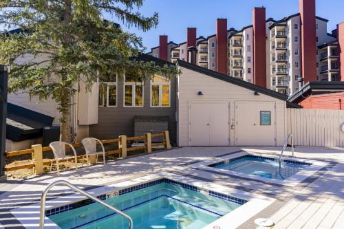 a swimming pool in a yard with a building at Torian Plum Plaza 302 in Steamboat Springs