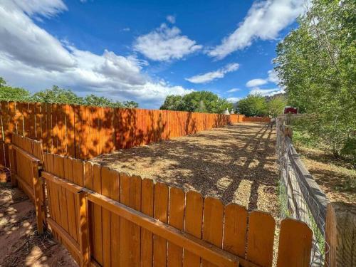 a wooden fence next to a dirt road at Desert Glamping Getaway Near Moab Arches NP in Moab