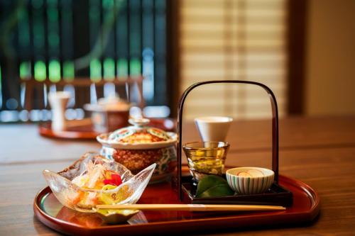 a tray of food on a table with a tray of food at Kappo Ryokan Yumesaki in Beppu