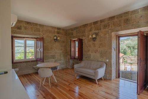 a living room with a couch and a table at Feel Discovery Casa da Granja Douro Valley in Resende
