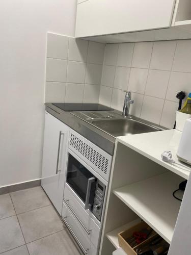 a kitchen with a sink and a microwave at Studios Harrachgass4 in Graz