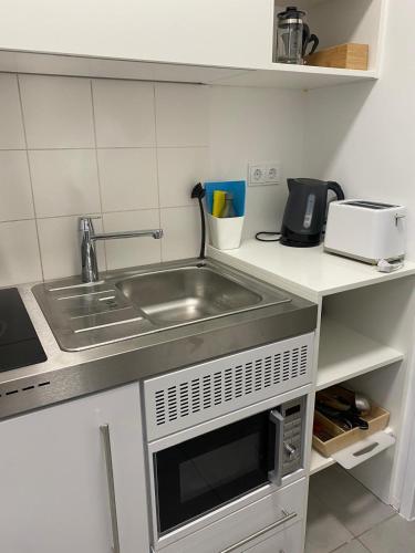 a kitchen with a sink and a microwave at Studios Harrachgass4 in Graz