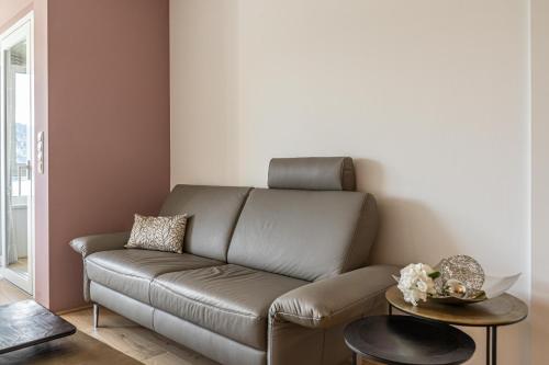 a living room with a couch and a table at Top 27 Alpe Maritima - Bergruh in Annenheim
