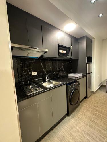 a kitchen with a stove and a sink at central apartment for rent 22 in Amman