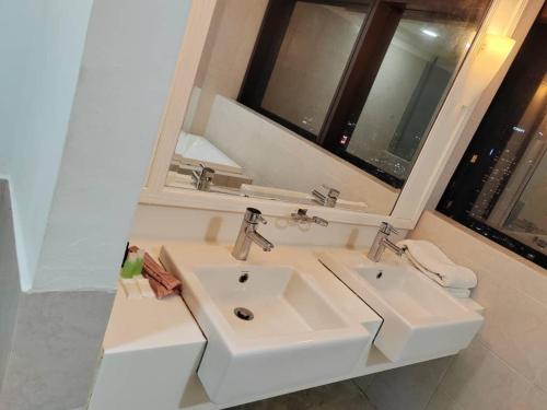 a bathroom with two sinks and a mirror at Kl Continew Suite At Times Square in Kuala Lumpur