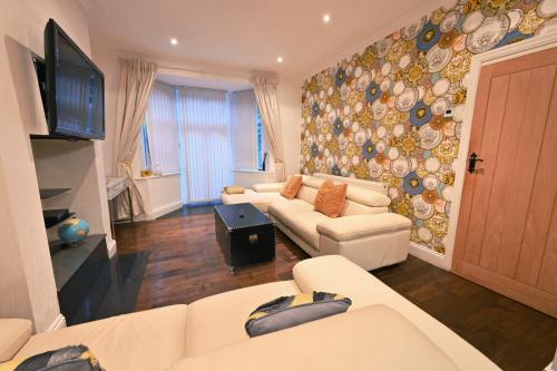 a living room with two couches and a tv at Grainger park in Newcastle upon Tyne