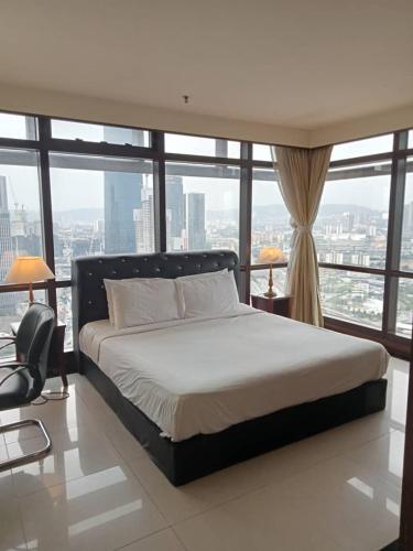 a bedroom with a bed and a large window at Kl Continew Suite At Times Square in Kuala Lumpur