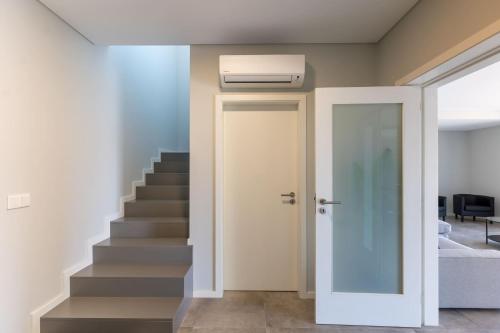 a hallway with a door leading up to a staircase at Feel Discovery Mirao River House Douro Valley in Resende