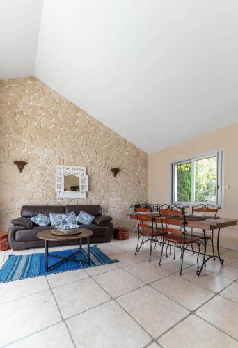 a living room with a couch and a table at La Petite Maison Gannat in Gannat