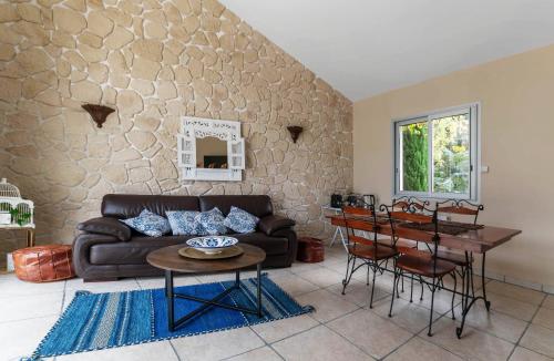 a living room with a couch and a table at La Petite Maison Gannat in Gannat