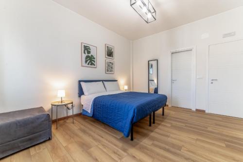 a bedroom with a bed with a blue blanket at Lorena Cozy Rooms - Ospedale Gemelli - WiFi in Rome