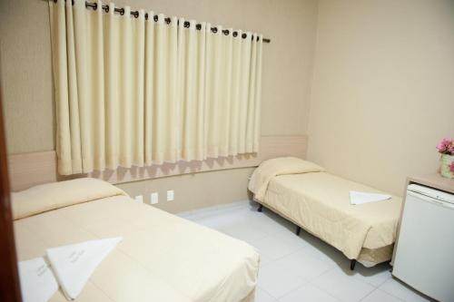 a hospital room with two beds and a window at Italian Palace Hotel in Palmas