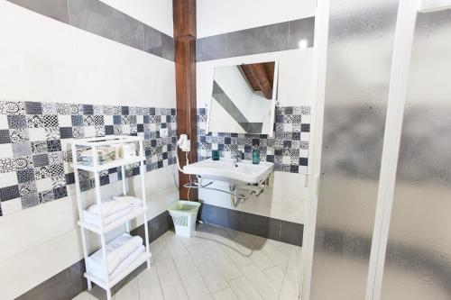 a bathroom with a sink and a mirror at Il Centenario in Ascea