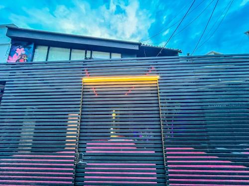 a wall with a yellow and red stripe on it at Antonia Poolside Autonomy Hotel in Ibagué