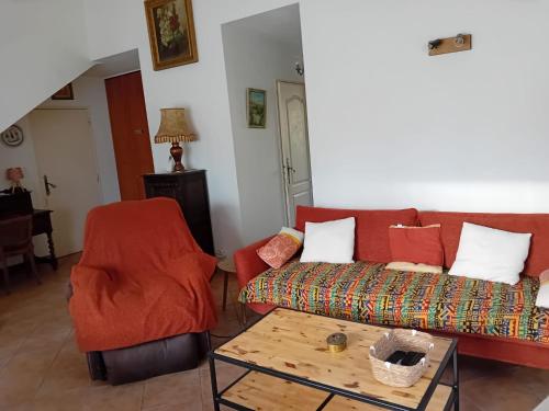 a living room with a couch and a table at Villa la Farigoulo in Juan-les-Pins