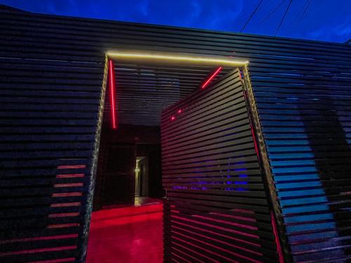 a black building with red lights on it at Antonia Poolside Autonomy Hotel in Ibagué