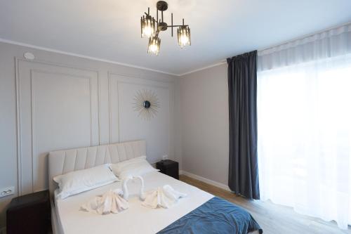 a bedroom with a bed with two white towels on it at Complex turistic Veverita in Ranca