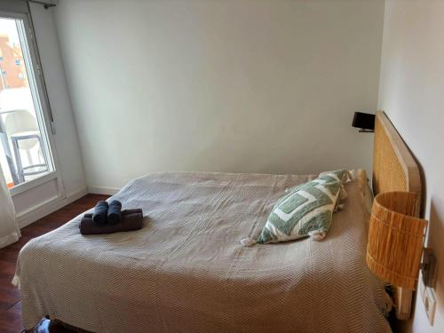 a bedroom with a bed with a pair of shoes on it at Encantador piso en Benimaclet in Valencia