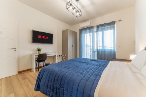a bedroom with a bed and a desk and a monitor at Lorena Cozy Rooms - Ospedale Gemelli - WiFi in Rome