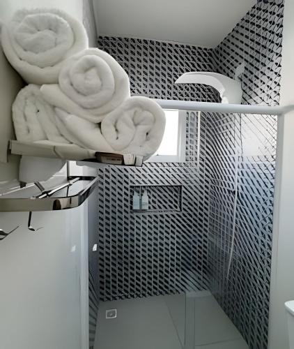 a bathroom with towels sitting on a shelf at Condomínio Canto da Ema in São Paulo