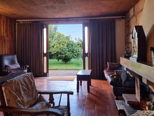a living room with a couch and a fireplace at Casa Nininha in Marco de Canaveses