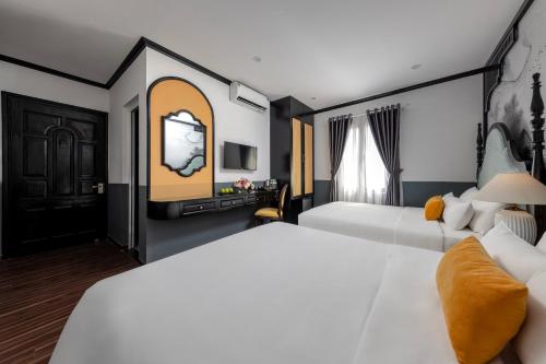 a hotel room with two beds and a tv at Hanoi Elpis Hotel & Spa in Hanoi