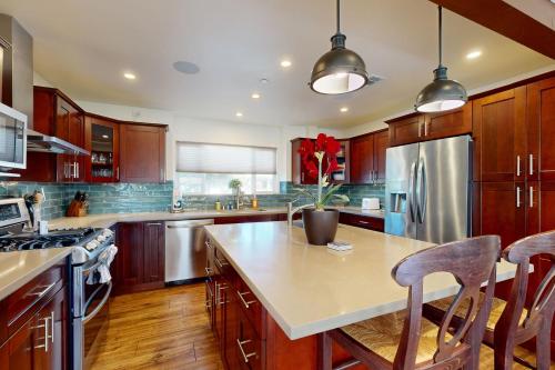 a kitchen with wooden cabinets and a large island at Brockton Diamond in Ventura