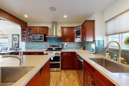 a kitchen with wooden cabinets and stainless steel appliances at Brockton Diamond in Ventura