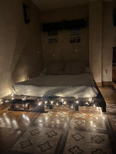 a bed with lights on the floor in a room at ESTUDIO LAS PALMILLAS in Puebla del Río