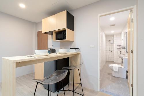 a kitchen with a desk and a chair in a bathroom at Wash House Chatuchak in Bangkok
