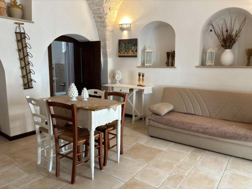 a living room with a table and a couch at Luxury trulli Sabotino in Alberobello