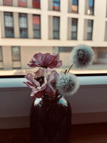 a black vase with flowers in a window at Ferienwohnung Schmalkalden in Schmalkalden