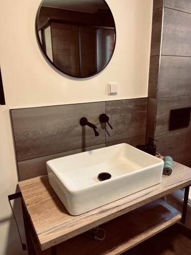 a bathroom with a white sink and a mirror at Ferienwohnung Schmalkalden in Schmalkalden