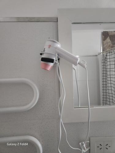 a blow dryer is hanging on a wall at Lugones in Ezeiza