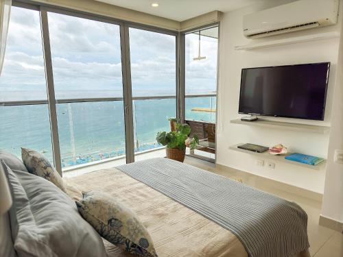 a bedroom with a bed and a large window at Namaste Alojamientos Luxury Cartagena in Cartagena de Indias