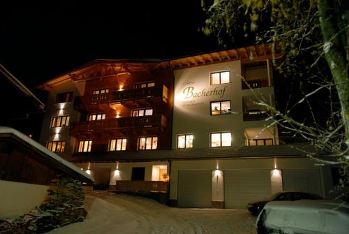 a building with a sign on it at night at Bacherhof in Sankt Anton am Arlberg