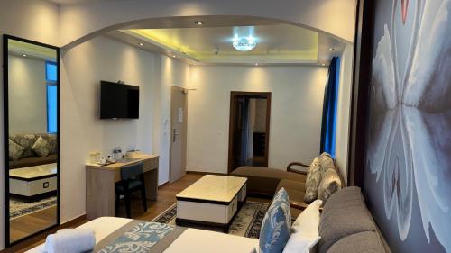 a hotel room with a bed and a living room at hotel whiteswan in Ehnen