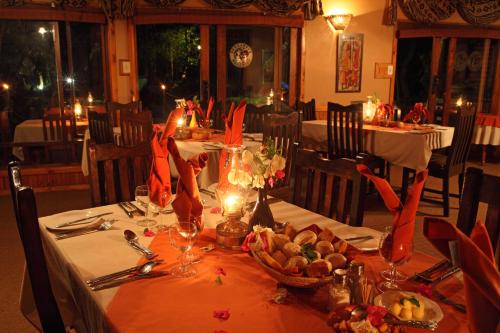 a table in a restaurant with a table set with food at Gooderson Bushlands Game Lodge in Hluhluwe
