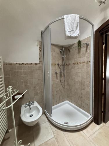 a bathroom with a shower and a toilet and a sink at Luxury Trulli Sabotino 48 in Alberobello