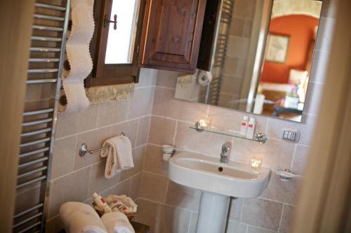a small bathroom with a sink and a mirror at Tenuta Monacelli Lecce in Lecce