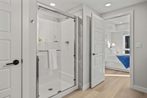a bathroom with a shower with a glass door at Outdoor heated pool and hot tub Stunning 3Bd sanctuary in Dead Man's Flats