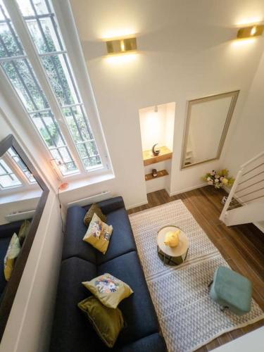 un salon avec un canapé bleu et une fenêtre dans l'établissement Île Saint Louis-studio, à Paris