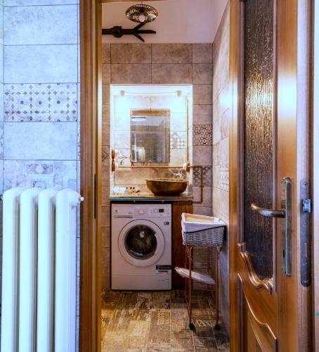 a bathroom with a washing machine and a sink at MaMa's Home in Abbadia Lariana
