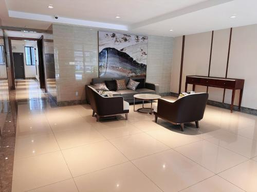 a lobby with a couch and chairs and a table at TheBess Hotel Tokyo is located adjacent to Singapore and offers a sea viewIt is a family business smart room with the sea view of Princess Bay富力公主湾 in Johor Bahru