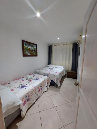 a room with two beds in a room with a window at VillaLore piscina exclusiva BBQ AC max 11 personas 5min playas in Carpintero
