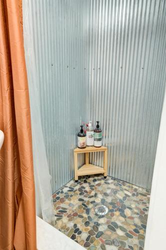 a table with two bottles on it next to a metal wall at Sleeps 5-6 Near RRG-Hot Tub-Nice Sunrise-Quiet in Beattyville