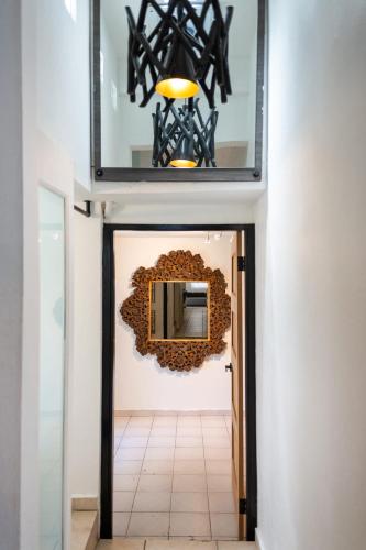 a mirror on the wall above a hallway at 24 Atlantic Place by Stay with Bear in San Juan