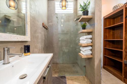 a bathroom with a sink and a shower at 24 Atlantic Place by Stay with Bear in San Juan