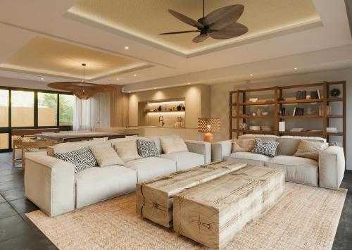 a living room with white furniture and a ceiling fan at Banyan Tree Mayakoba in Playa del Carmen