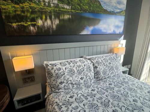 a bedroom with a bed with a large painting on the wall at Kinlay Hostel Eyre Square in Galway